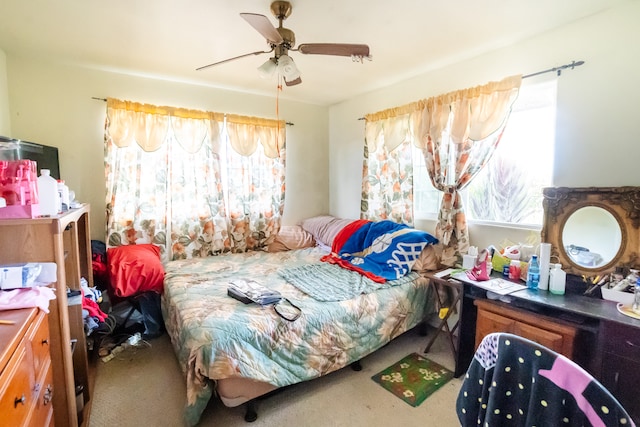 bedroom with carpet floors, multiple windows, and ceiling fan