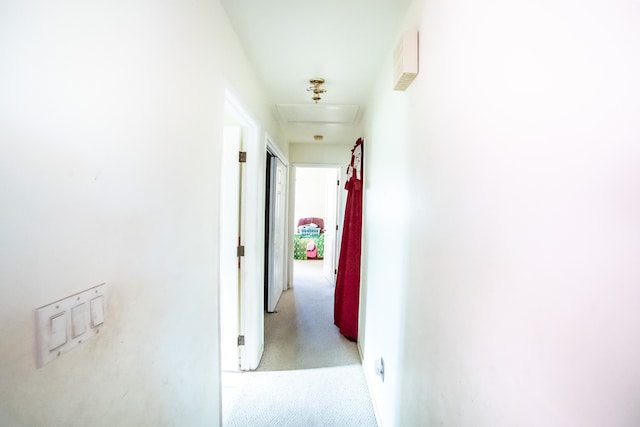 hallway featuring light colored carpet