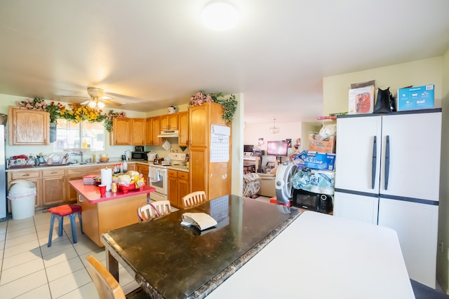 tiled dining space with ceiling fan