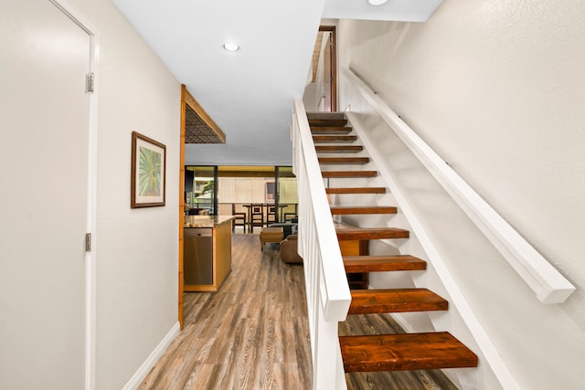 stairs featuring wood-type flooring