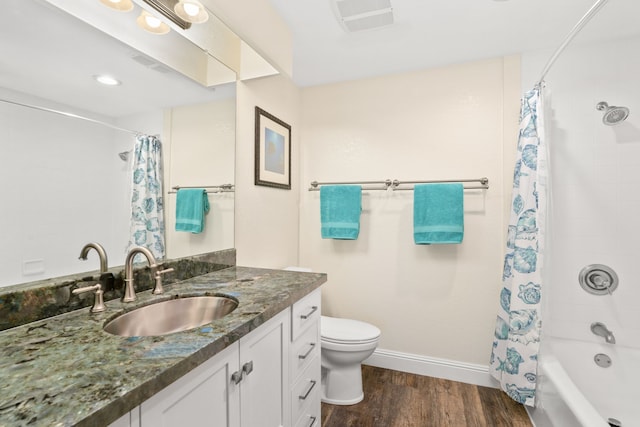 full bathroom with hardwood / wood-style flooring, shower / bath combination with curtain, vanity, and toilet