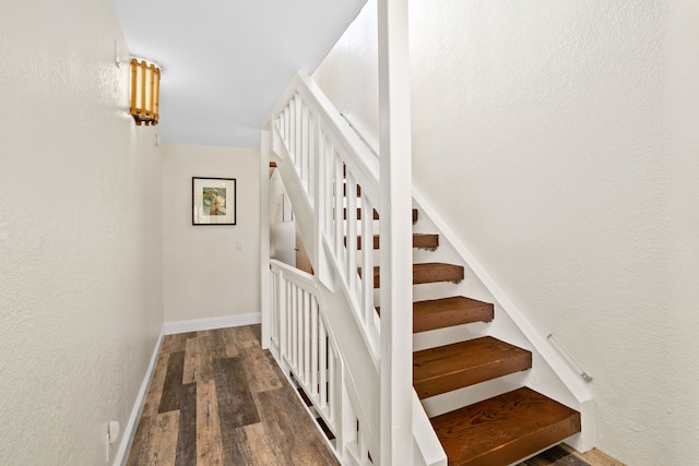 stairs featuring wood-type flooring