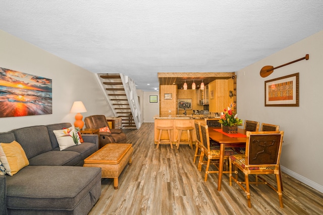 living room featuring a textured ceiling and hardwood / wood-style flooring