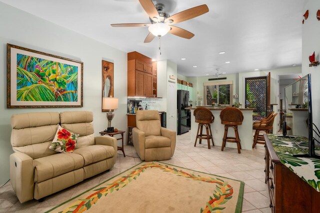 living room with ceiling fan and light tile patterned floors