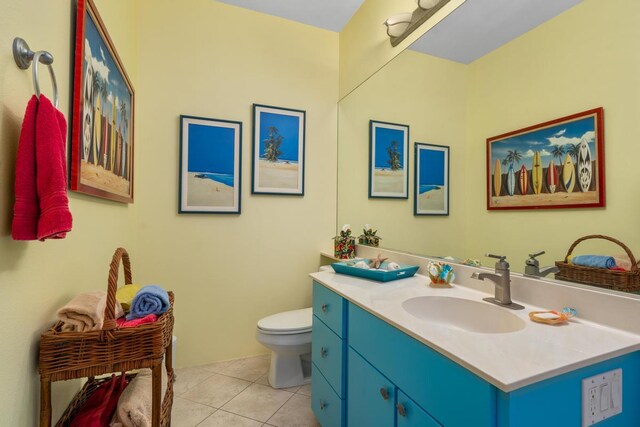 bathroom featuring tile patterned flooring, vanity, and toilet