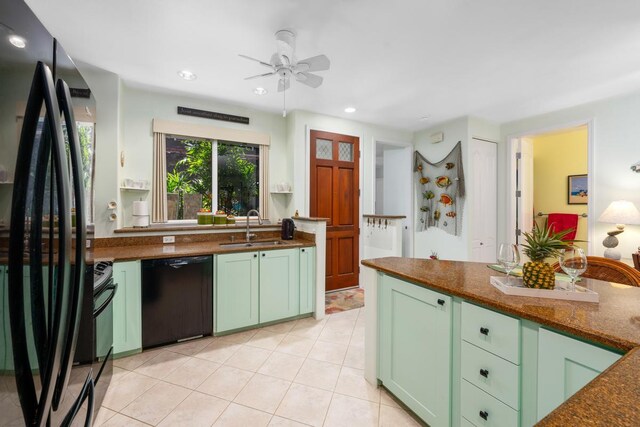 kitchen with black appliances, ceiling fan, green cabinets, and sink