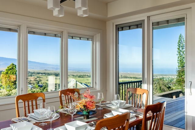 sunroom with a mountain view and a chandelier