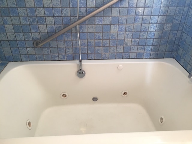 bathroom with a tub to relax in