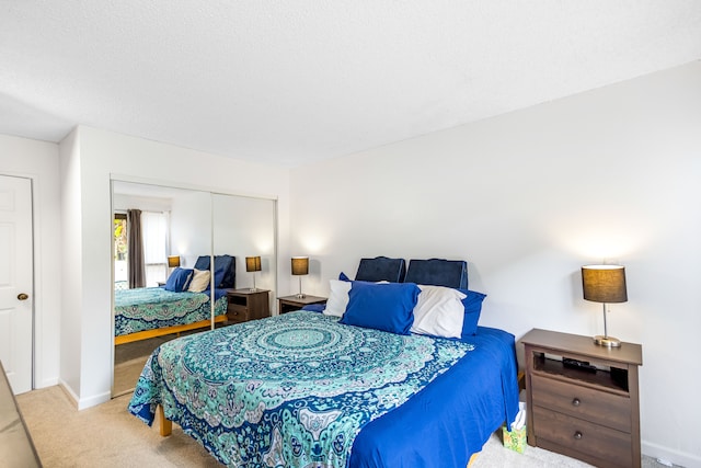 carpeted bedroom with a closet and a textured ceiling