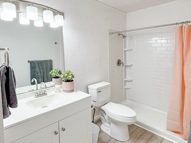 bathroom featuring hardwood / wood-style floors, toilet, a shower with curtain, and vanity