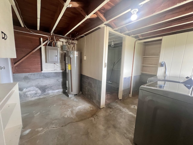 basement with washer and dryer, electric water heater, and electric panel