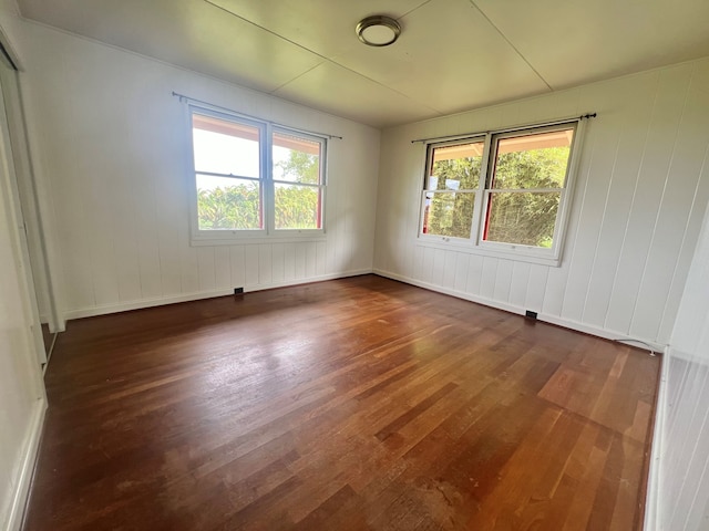 spare room featuring dark hardwood / wood-style flooring