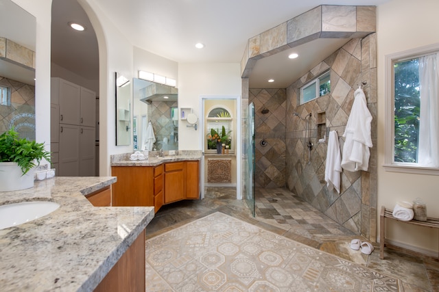 bathroom featuring walk in shower and vanity