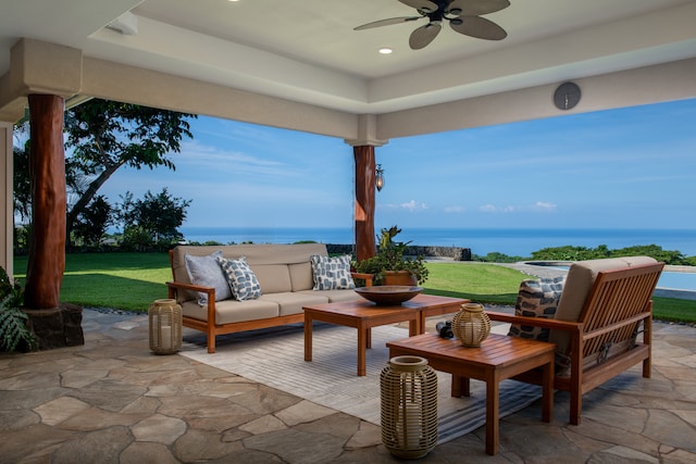 view of patio / terrace with a water view, ceiling fan, and outdoor lounge area