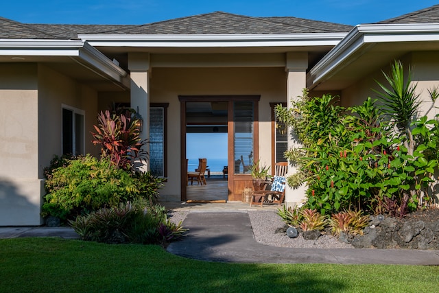 property entrance featuring a patio area and a yard