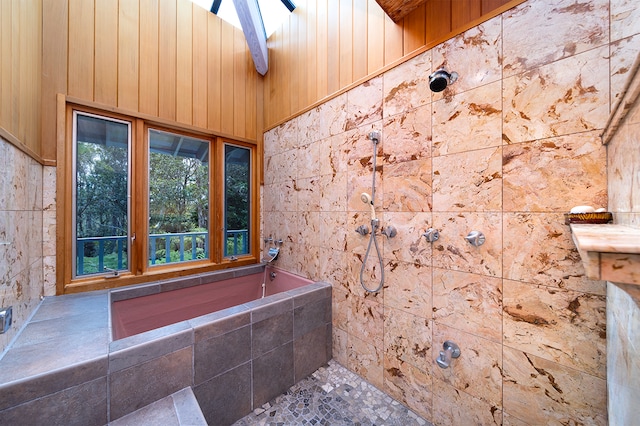 bathroom featuring wood walls and shower with separate bathtub