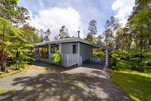 view of side of home with a yard