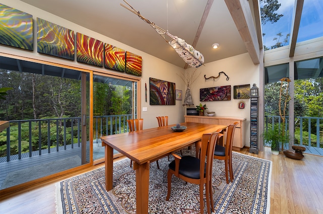 dining room with beamed ceiling and hardwood / wood-style floors