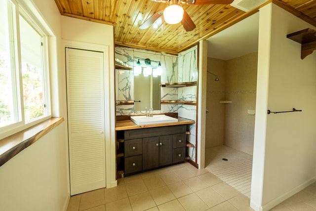 bathroom featuring tile patterned flooring, wooden ceiling, vanity, and tiled shower