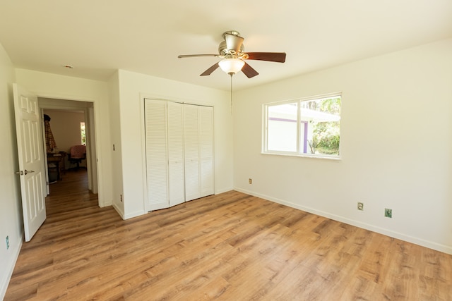 unfurnished bedroom featuring a closet, light wood-type flooring, and ceiling fan