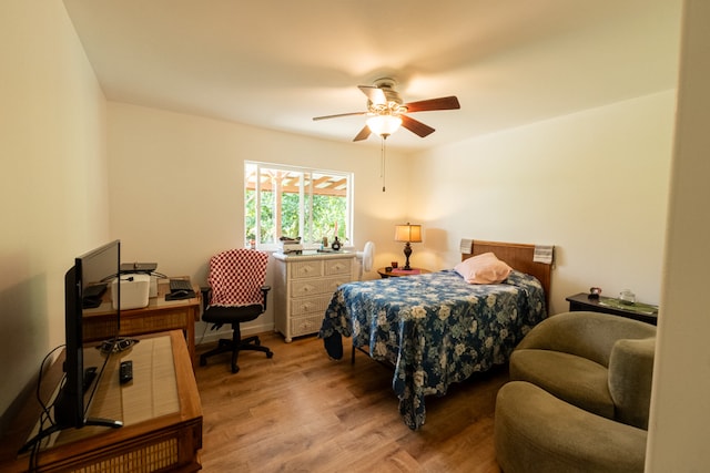 bedroom with light hardwood / wood-style floors and ceiling fan