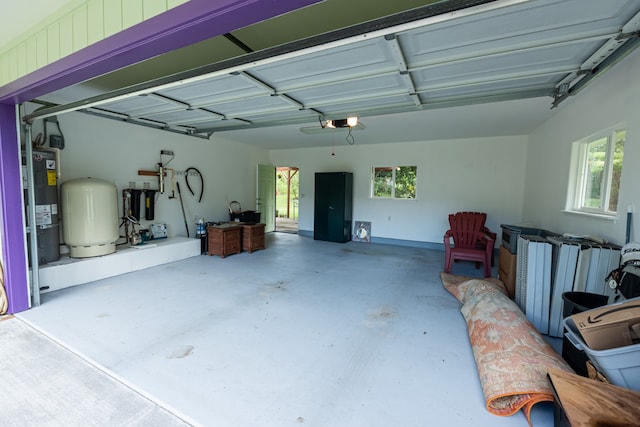 garage featuring strapped water heater and a garage door opener