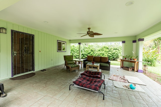 view of patio with an outdoor living space and ceiling fan