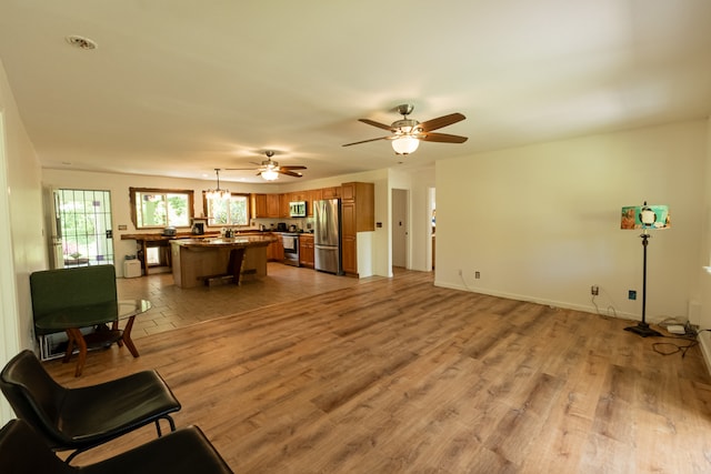 living room featuring ceiling fan and light wood-type flooring