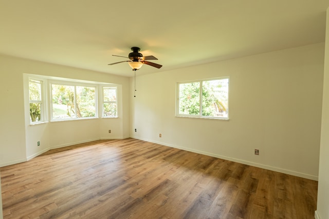 unfurnished room featuring ceiling fan and light wood-type flooring