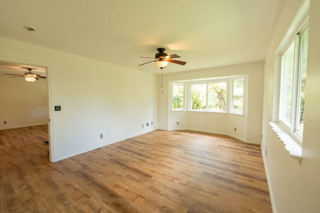 spare room with light hardwood / wood-style floors and ceiling fan