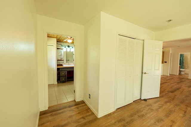 hall with hardwood / wood-style floors and sink