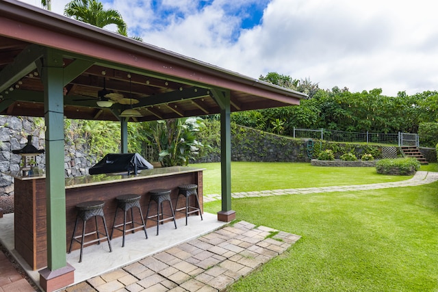 view of yard featuring an outdoor bar, ceiling fan, a patio area, and a gazebo