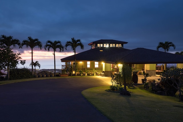 view of front facade featuring a yard and a carport