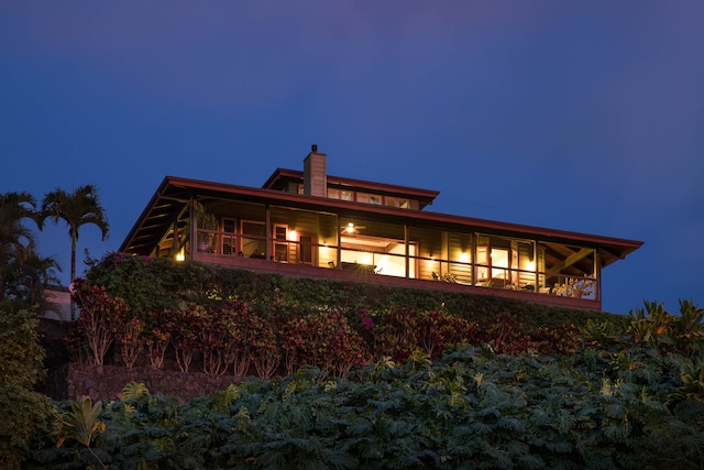 view of back house at twilight