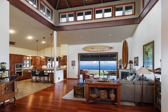 living room featuring hardwood / wood-style floors and high vaulted ceiling