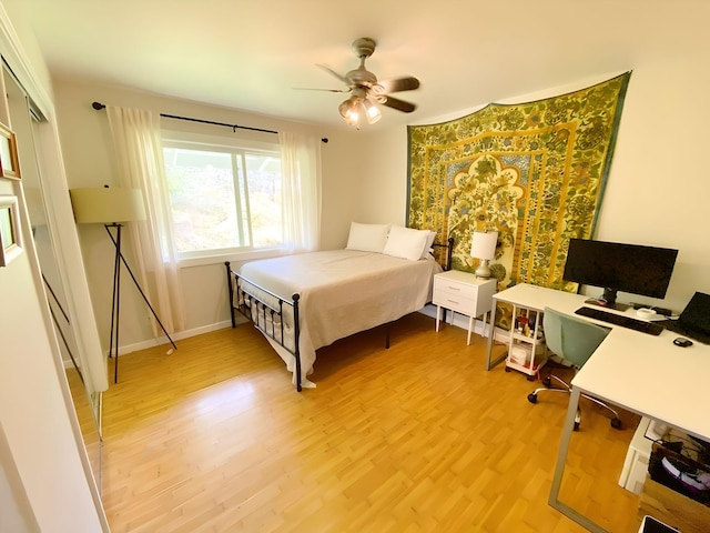 bedroom with ceiling fan and light hardwood / wood-style flooring