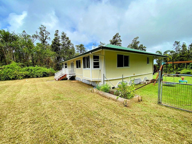 view of side of home featuring a lawn