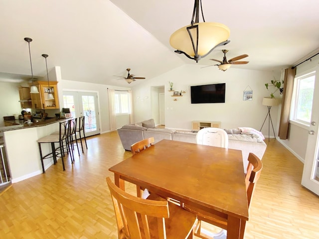 dining room with lofted ceiling, ceiling fan, and french doors