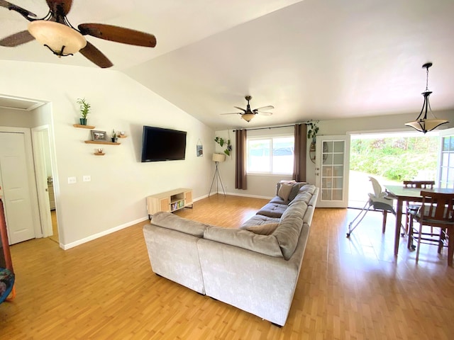 living room featuring ceiling fan, lofted ceiling, and hardwood / wood-style floors