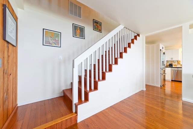 stairs with wood-type flooring