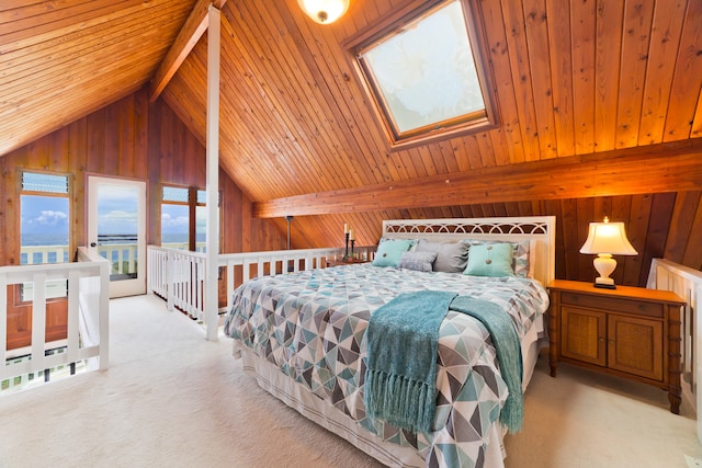 carpeted bedroom with vaulted ceiling with skylight, wooden walls, and wood ceiling