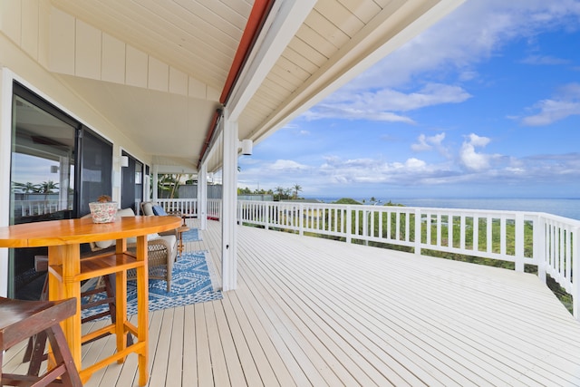 wooden terrace featuring a water view