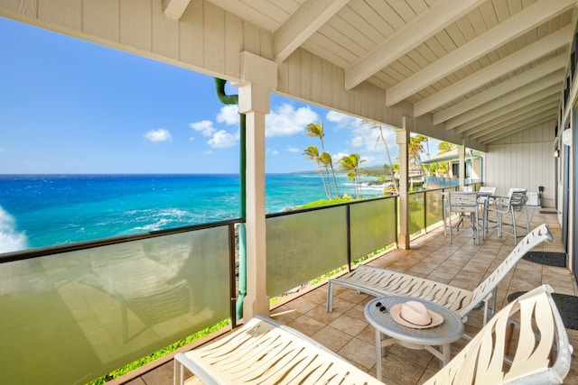 balcony featuring a patio area and a water view