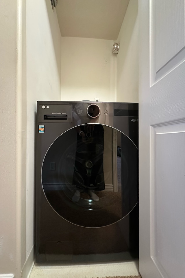 clothes washing area featuring washer / clothes dryer