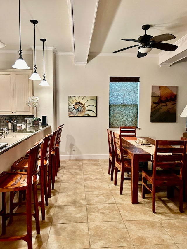 tiled dining space with ornamental molding and ceiling fan