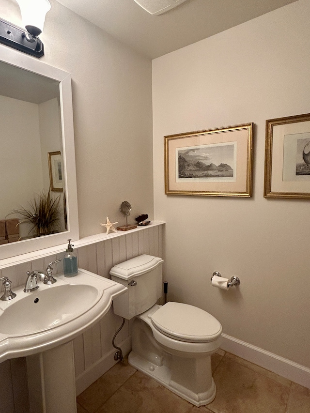 bathroom with tile patterned flooring and toilet