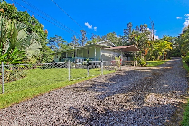 view of front of house featuring a front lawn and a carport