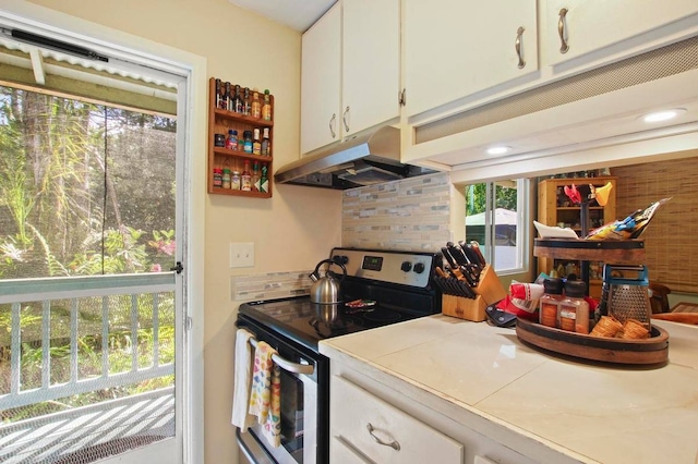 kitchen featuring a healthy amount of sunlight, white cabinetry, and stainless steel range with electric cooktop