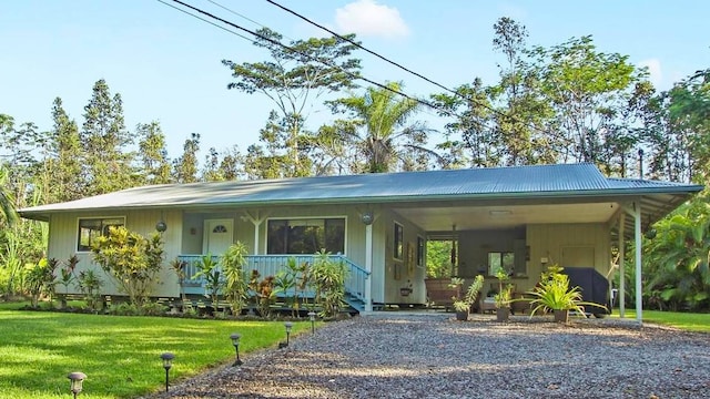 view of front of home with a carport and a front lawn