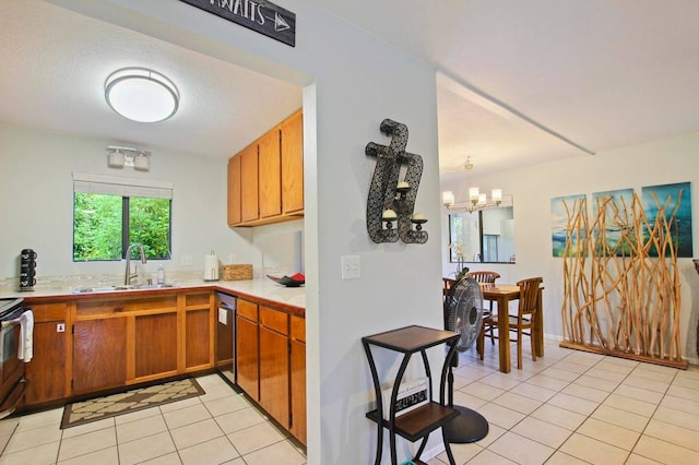 kitchen with dishwasher, sink, light tile patterned floors, decorative light fixtures, and a chandelier